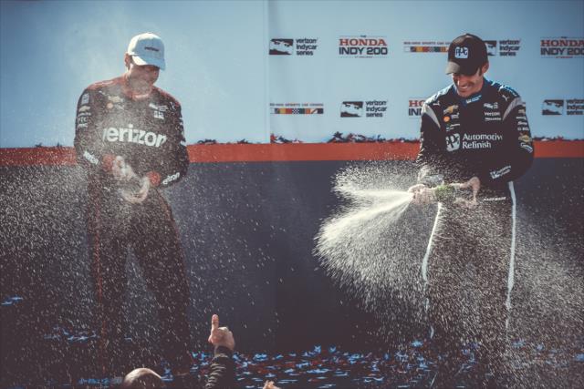 Teammates Will Power and Simon Pagenaud spray the champagne in Victory Circle following the Honda Indy 200 at Mid-Ohio -- Photo by: Joe Skibinski