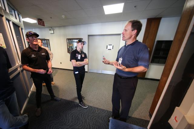 A NASA representative describes the wind tunnel complex to Scott Dixon and Indy Lights driver Ryan Normal during their visit to the NASA Glenn Research Center in Cleveland, OH -- Photo by: Joe Skibinski