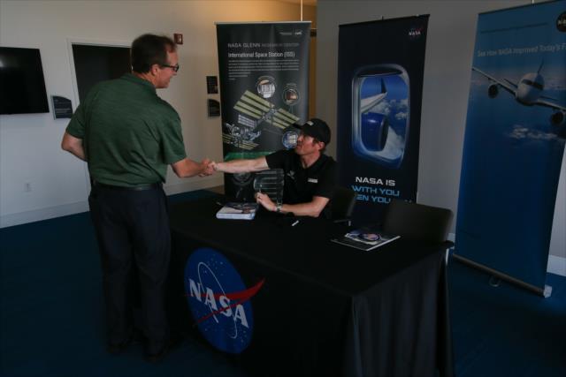 Scott Dixon greets a NASA engineer at the NASA Glenn Research Center in Cleveland, OH -- Photo by: Joe Skibinski