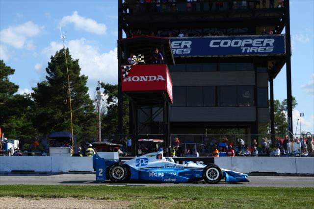 Josef Newgarden takes the twin checkers to win the Honda Indy 200 at Mid-Ohio -- Photo by: Bret Kelley