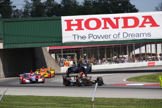 James Hinchcliffe leads a group under the Honda bridge into Turn 1 during the Honda Indy 200 at Mid-Ohio -- Photo by: Bret Kelley