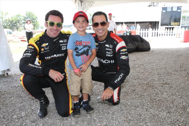 Simon Pagenaud and Helio Castroneves with a young fan at Mid-Ohio -- Photo by: Chris Jones