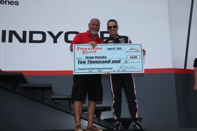 Helio Castroneves accepts the Firestone Pit Stop Performance Award on behalf of Team Penske for their performance in Toronto -- Photo by: Chris Jones