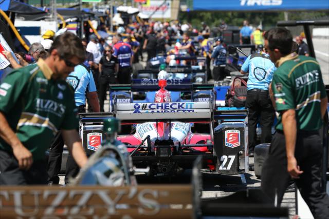 Teams look over their respective machines on pit lane prior to the final warmup for the Honda Indy 200 at Mid-Ohio -- Photo by: Chris Jones