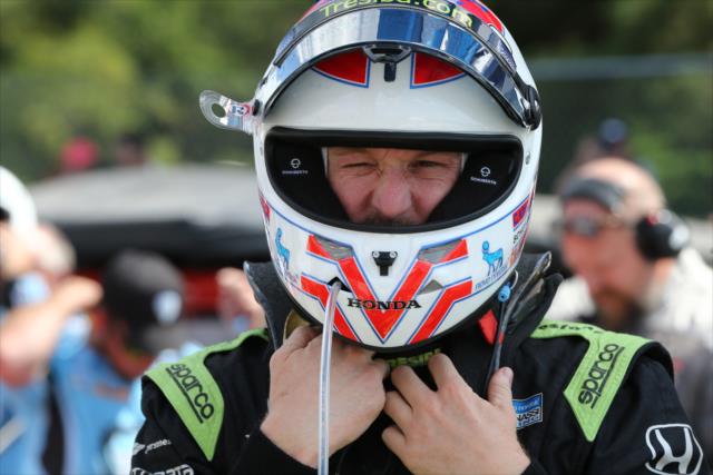 Charlie Kimball adjusts his helmet along pit lane during pre-race festivities for the Honda Indy 200 at Mid-Ohio -- Photo by: Chris Jones