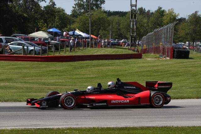 Mario Andretti and former MLB slugger Travis Hafner in the two-seater during the parade laps prior to the start of the Honda Indy 200 at Mid-Ohio -- Photo by: Chris Jones
