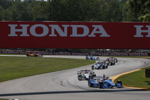 Scott Dixon leads a group through Turns 6-7 under the Honda bridge during the Honda Indy 200 at Mid-Ohio -- Photo by: Joe Skibinski