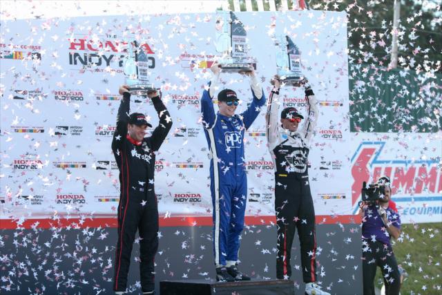 The confetti flies in Victory Circle as Josef Newgarden, Will Power, and Graham Rahal hoist their trophies following the Honda Indy 200 at Mid-Ohio -- Photo by: Joe Skibinski