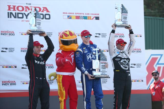 The podium of Josef Newgarden, Will Power, and Graham Rahal with the Firestone Firehawk in Victory Circle following the Honda Indy 200 at Mid-Ohio -- Photo by: Joe Skibinski