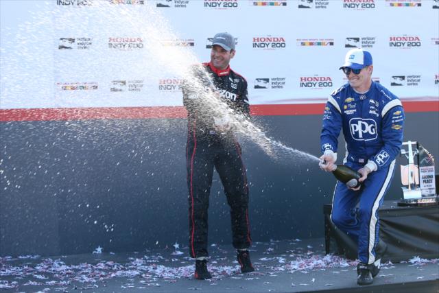 Josef Newgarden and Will Power spray the champagne in Victory Circle following the Honda Indy 200 at Mid-Ohio -- Photo by: Joe Skibinski