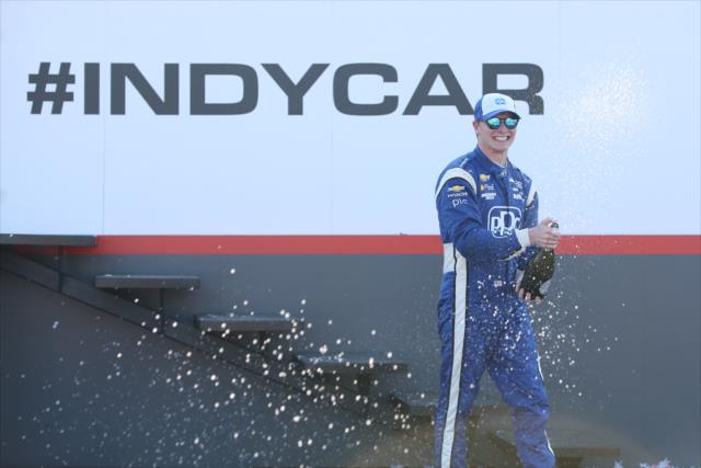 Josef Newgarden sprays the champagne in Victory Circle following his win in the Honda Indy 200 at Mid-Ohio -- Photo by: Joe Skibinski