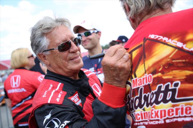 Mario Andretti signs an autograph during pre-race festivities for the Honda Indy 200 at Mid-Ohio -- Photo by: Matt Fraver