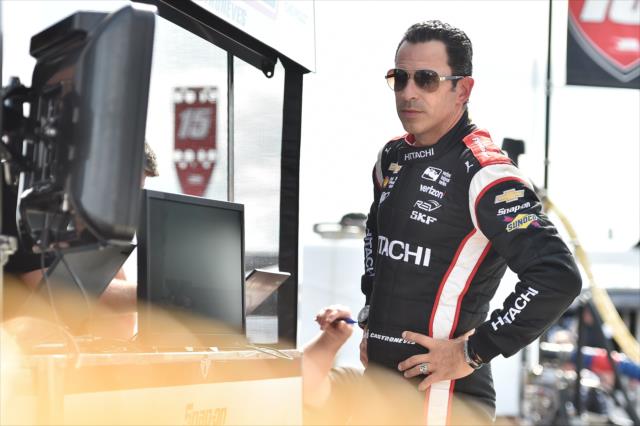 Helio Castroneves looks over data from his pit stall prior to practice for the ABC Supply 500 at Pocono Raceway -- Photo by: Chris Owens