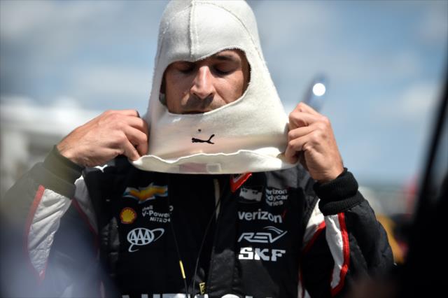 Helio Castroneves slides on his balaclava on pit lane prior to practice for the ABC Supply 500 at Pocono Raceway -- Photo by: Chris Owens