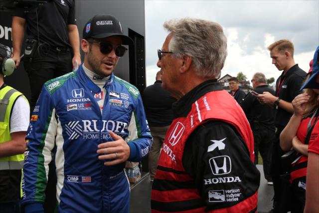 Marco Andretti chats with his grandfather, Mario Andretti, during pre-race festivities for the Honda Indy 200 at Mid-Ohio -- Photo by: Chris Jones