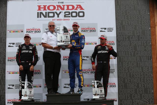Alexander Rossi accepts his 1st Place trophy in Victory Circle after winning the Honda Indy 200 at Mid-Ohio -- Photo by: Chris Jones