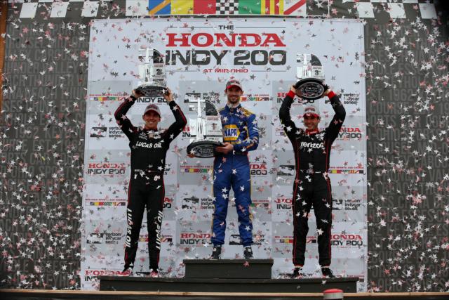 The confetti flies over Victory Circle as Alexander Rossi, Robert Wickens, and Will Power hoist their trophies following the Honda Indy 200 at Mid-Ohio -- Photo by: Chris Jones