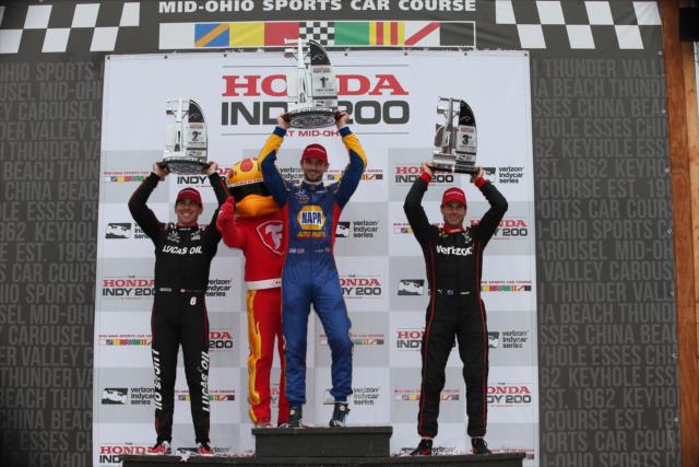 Alexander Rossi, Robert Wickens, and Will Power hoist their trophies in Victory Circle following the Honda Indy 200 at Mid-Ohio -- Photo by: Chris Jones