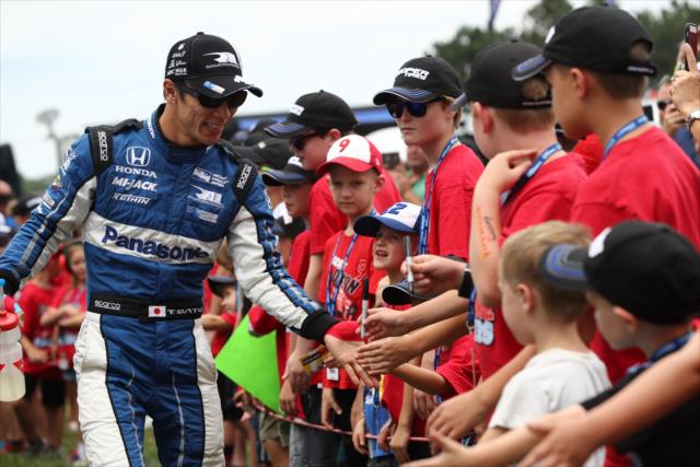 Takuma Sato greets the young fans in front of the stage during pre-race introductions for the Honda Indy 200 at Mid-Ohio -- Photo by: Chris Jones