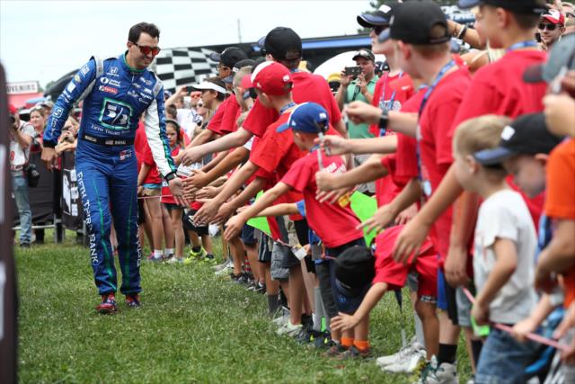 Ohioan Graham Rahal greets the young fans in front of the stage during pre-race introductions for the Honda Indy 200 at Mid-Ohio -- Photo by: Chris Jones