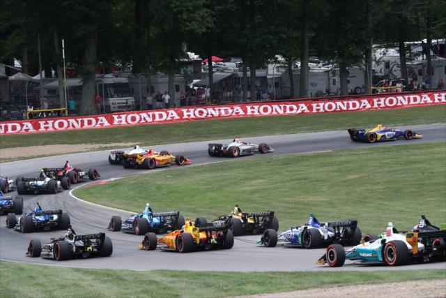 The field tears down the track into Turn 6 during the start of the Honda Indy 200 at Mid-Ohio -- Photo by: Chris Jones