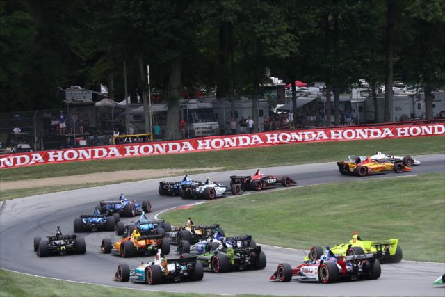 The field streams into Turn 6 during the start of the Honda Indy 200 at Mid-Ohio -- Photo by: Chris Jones
