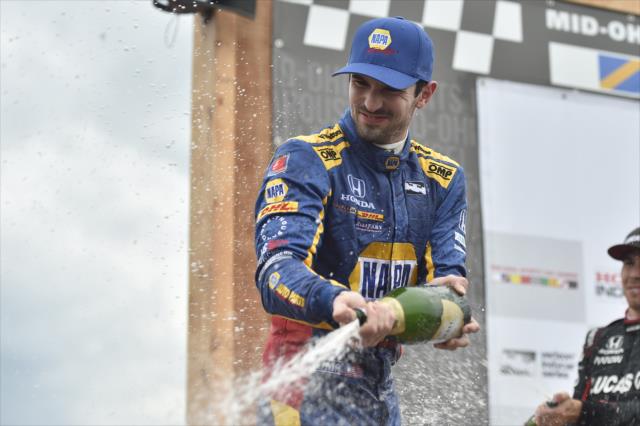Alexander Rossi sprays the champagne in Victory Circle after winning the Honda Indy 200 at Mid-Ohio -- Photo by: Chris Owens