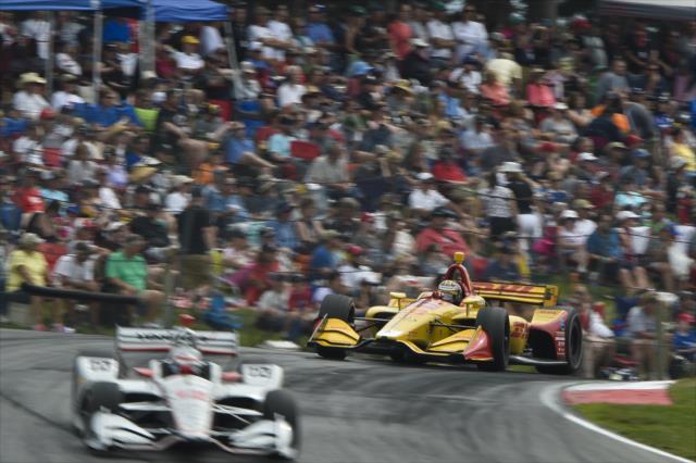 Will Power and Ryan Hunter-Reay launch over the Turn 5 hill during the Honda Indy 200 at Mid-Ohio -- Photo by: Chris Owens