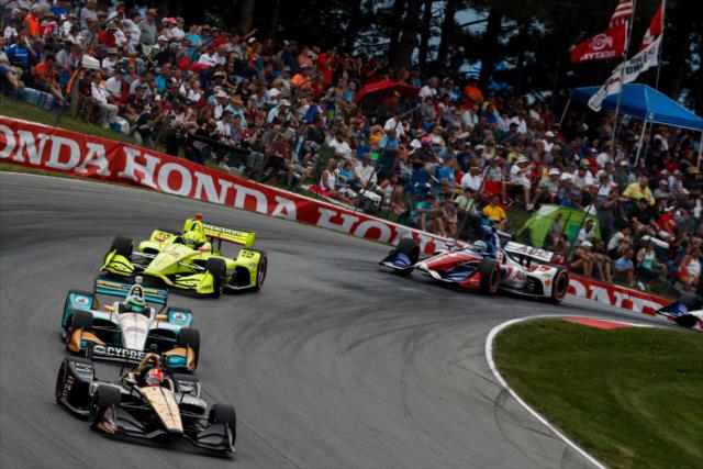 James Hinchcliffe leads a train of cars over the Turn 5 hill during the Honda Indy 200 at Mid-Ohio -- Photo by: Joe Skibinski