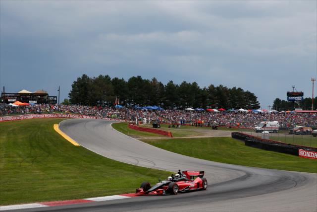 Mario Andretti pilots the two-seater through Turn 6 during the parade laps prior to the start of the Honda Indy 200 at Mid-Ohio -- Photo by: Joe Skibinski