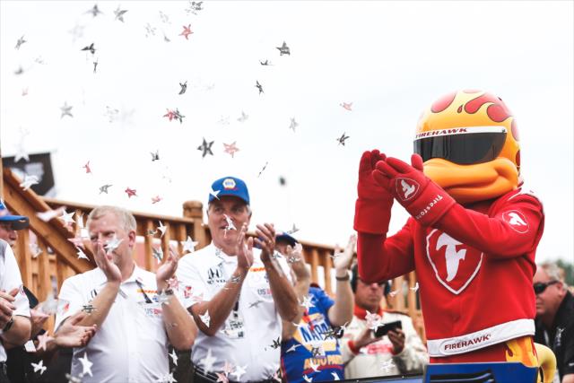 The Firestone Firehawk applauds in Victory Circle for Alexander Rossi following the Honda Indy 200 at Mid-Ohio -- Photo by: Joe Skibinski