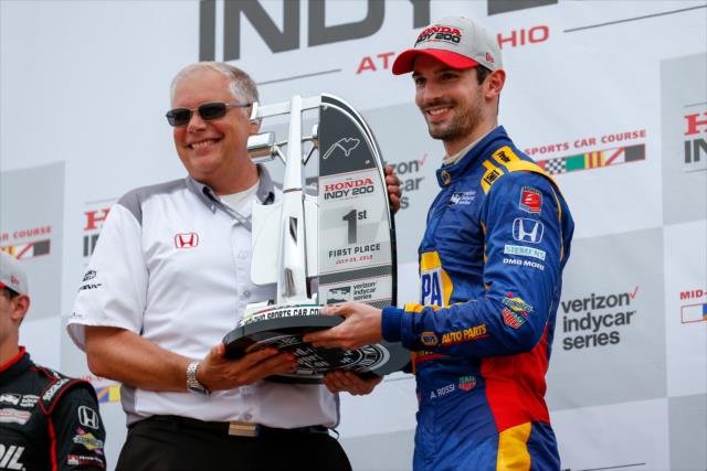 Alexander Rossi accepts his 1st Place trophy in Victory Circle after winning the Honda Indy 200 at Mid-Ohio -- Photo by: Joe Skibinski