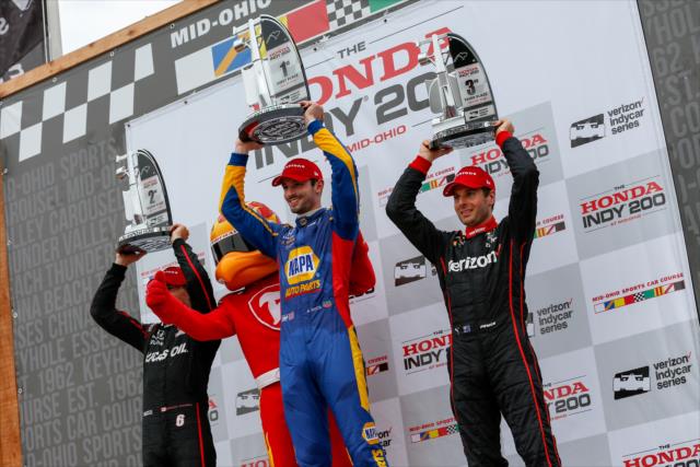 The podium of Alexander Rossi, Robert Wickens, and Will Power hoist their trophies in Victory Circle following the Honda Indy 200 at Mid-Ohio -- Photo by: Joe Skibinski