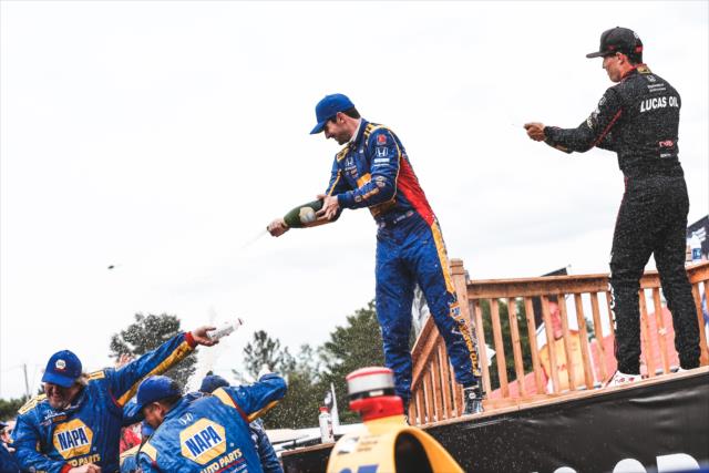 Alexander Rossi and Robert Wickens spray the champagne in Victory Circle following the Honda Indy 200 at Mid-Ohio -- Photo by: Joe Skibinski