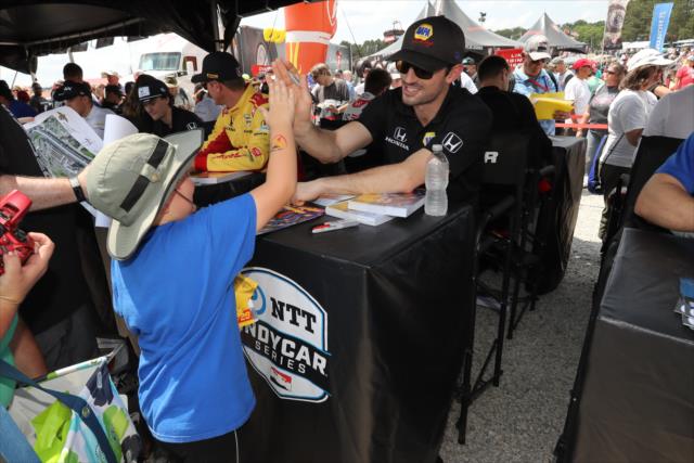 Alexander Rossi and young fan -- Photo by: Chris Jones