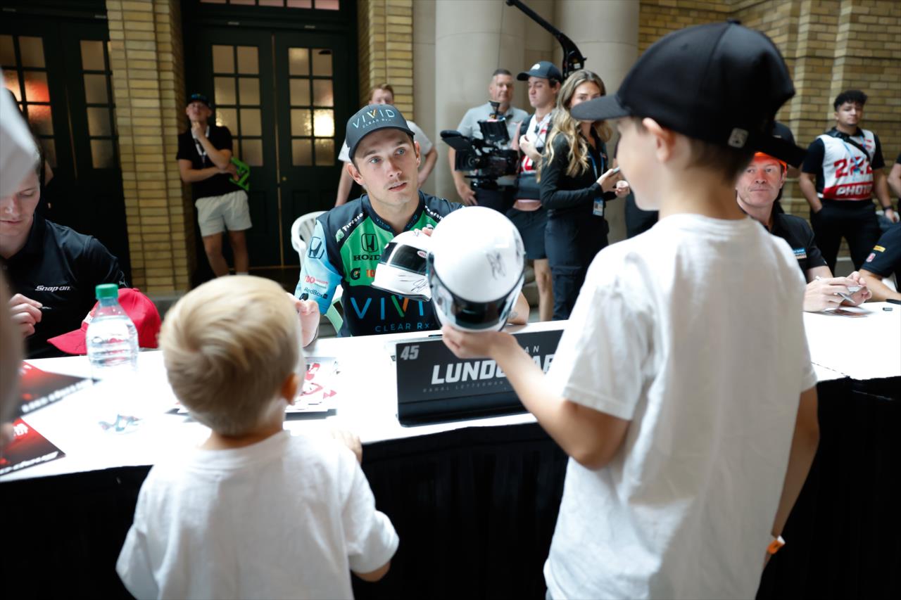Christian Lundgaard signs an autograph for a fan - Honda Indy Toronto - By: Joe Skibinski -- Photo by: Joe Skibinski
