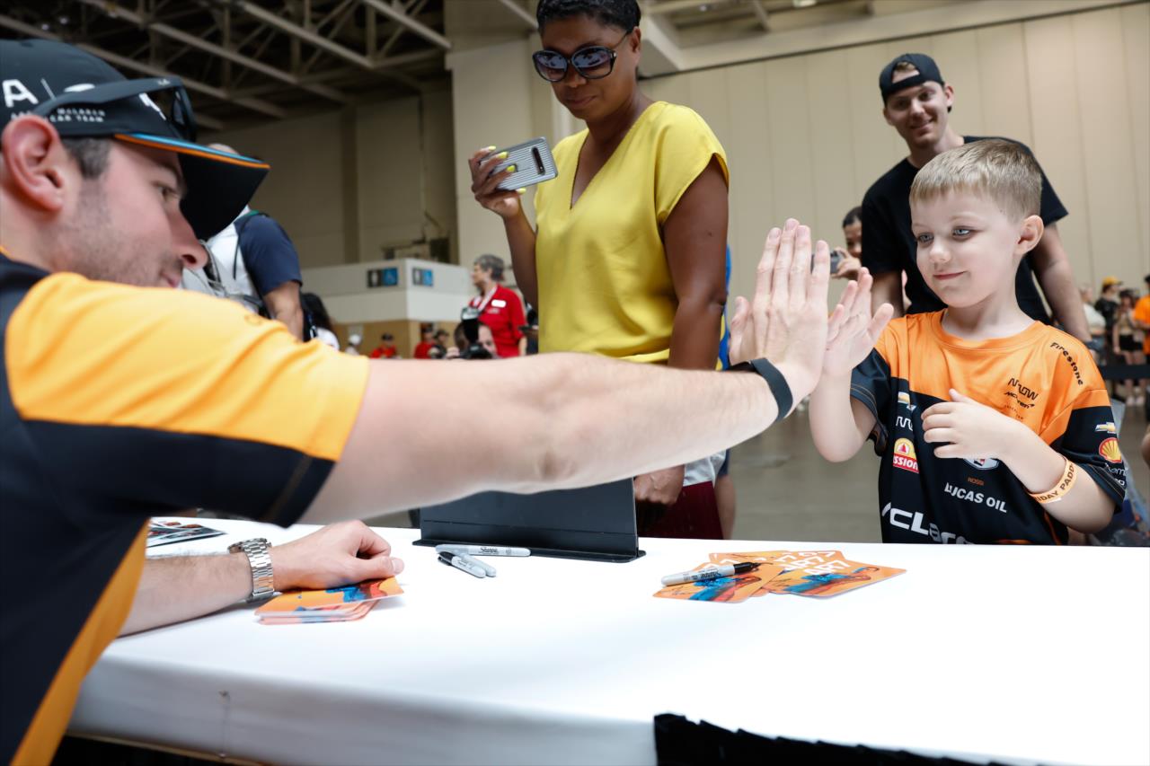 Alexander Rossi gives a high five to a young fan - Honda Indy Toronto - By: Joe Skibinski -- Photo by: Joe Skibinski