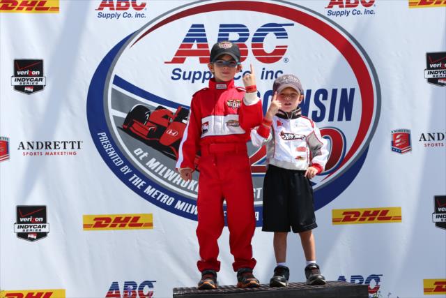 Young fans pose on the Milwaukee Mile podium -- Photo by: Chris Jones