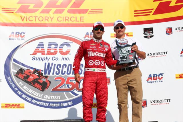 Tony Kanaan accepts his 3rd Place trophy in Victory Circle for the ABC Supply Wisconsin 250 at the Milwaukee Mile -- Photo by: Chris Jones