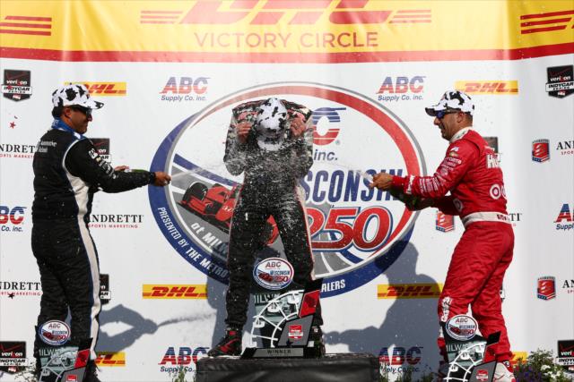 Juan Pablo Montoya and Tony Kanaan spray champagne towards Will Power in Victory Lane following the ABC Supply Wisconsin 250 at the Milwaukee Mile -- Photo by: Chris Jones