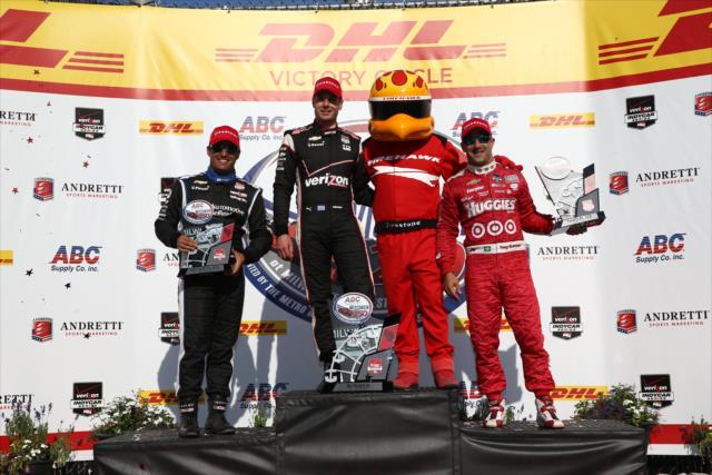 The podium of Will Power, Juan Pablo Montoya, and Tony Kanaan pose with the Firestone Firehawk in Victory Circle at the Milwaukee Mile -- Photo by: Chris Jones