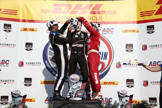 Juan Pablo Montoya and Tony Kanaan pour champagne down Will Power's firesuit in Victory Circle following the ABC Supply Wisconsin 250 at the Milwaukee Mile -- Photo by: Chris Jones