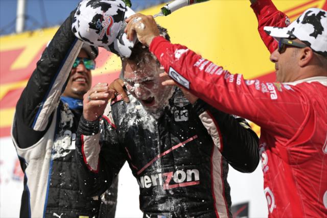 Will Power receives a champagne shower in Victory Circle at the Milwaukee Mile from Juan Pablo Montoya and Tony Kanaan -- Photo by: Shawn Gritzmacher