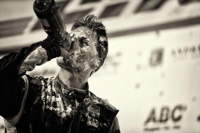 Will Power swigs the champagne in Victory Circle after winning the ABC Supply Wisconsin 250 at the Milwaukee Mile -- Photo by: Shawn Gritzmacher