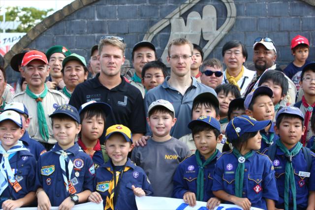 James Jakes and Sebastien Bourdais pose with some Japanese Boy Scouts -- Photo by: Chris Jones