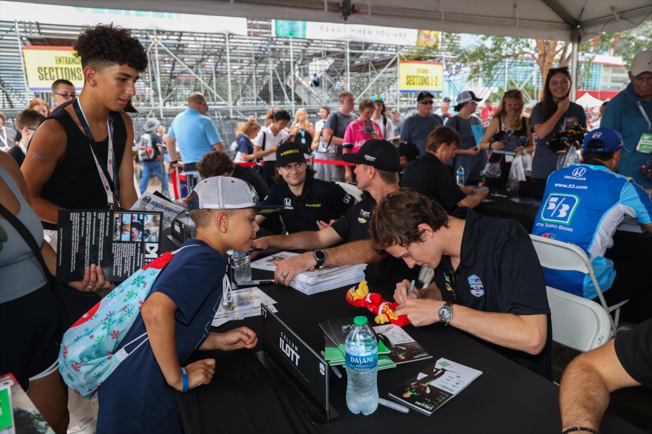 Callum Ilott signs an autograph for a young fan - Big Machine Music City Grand Prix - By: Travis Hinkle -- Photo by: Travis Hinkle