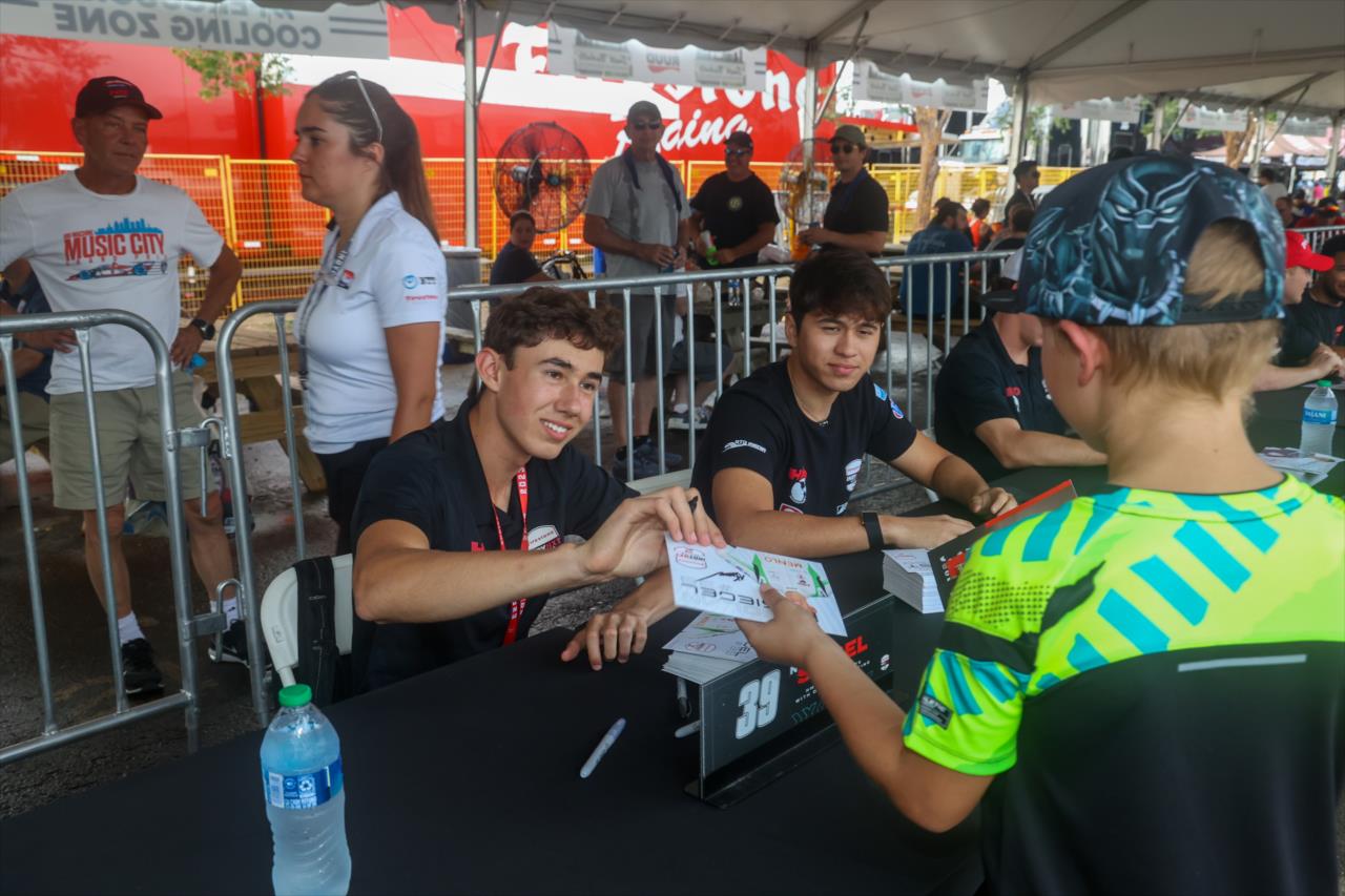 Nolan Siegel signs an autograph for a fan - INDY NXT By Firestone Music City Grand Prix - By: Travis Hinkle -- Photo by: Travis Hinkle