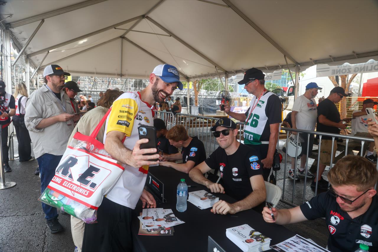 Christian Bogle takes a photo with a fan - INDY NXT By Firestone Music City Grand Prix - By: Travis Hinkle -- Photo by: Travis Hinkle