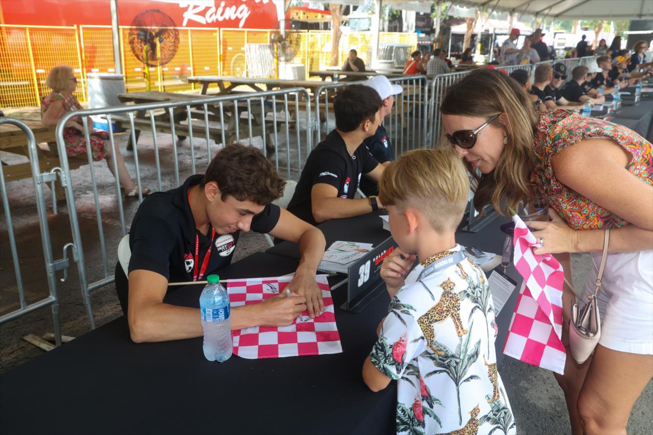 Nolan Siegel signs an autograph for a young fan - INDY NXT By Firestone Music City Grand Prix - By: Travis Hinkle -- Photo by: Travis Hinkle