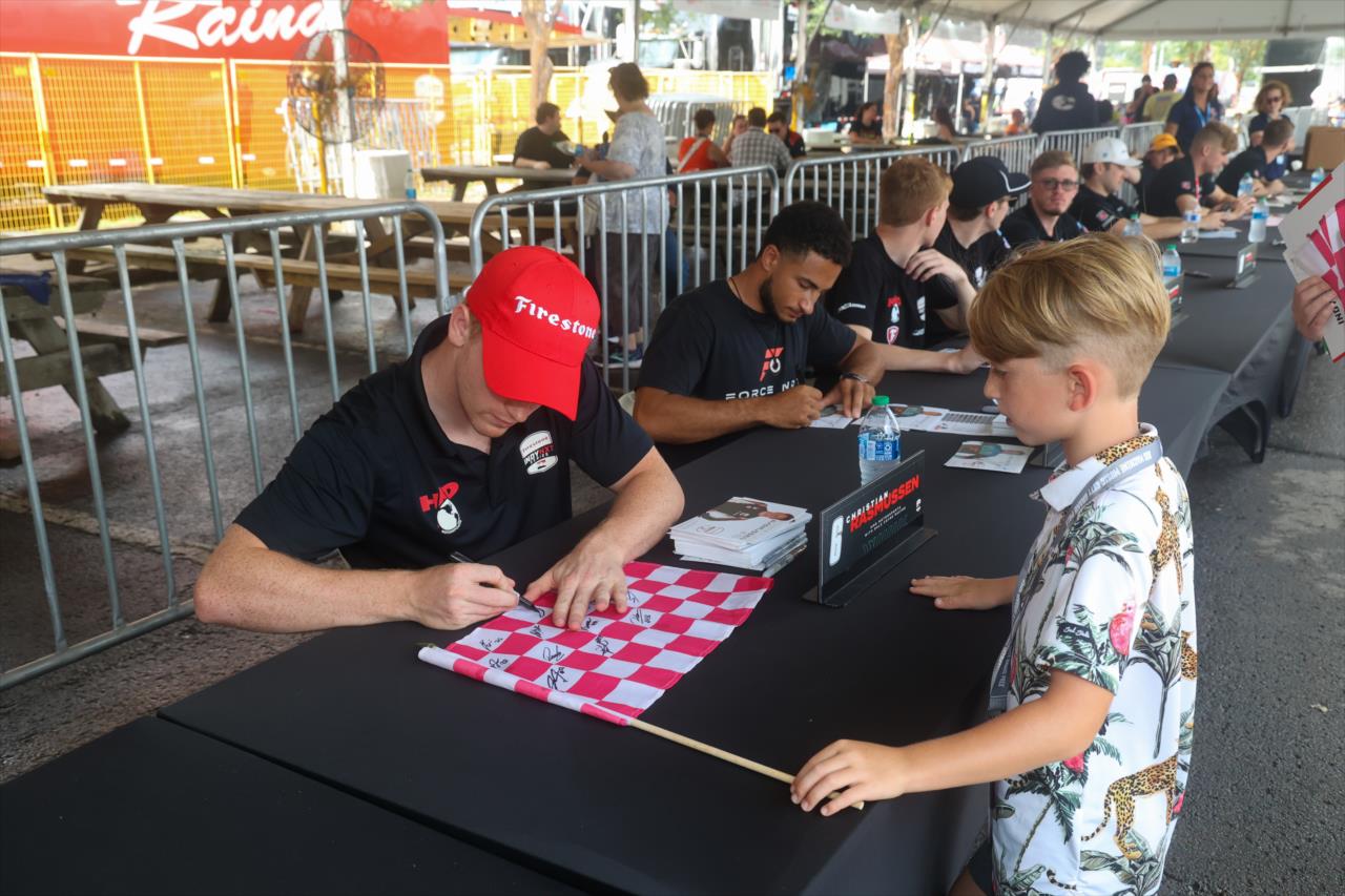 Jacob Abel signs an autograph for a young fan - INDY NXT By Firestone Music City Grand Prix - By: Travis Hinkle -- Photo by: Travis Hinkle